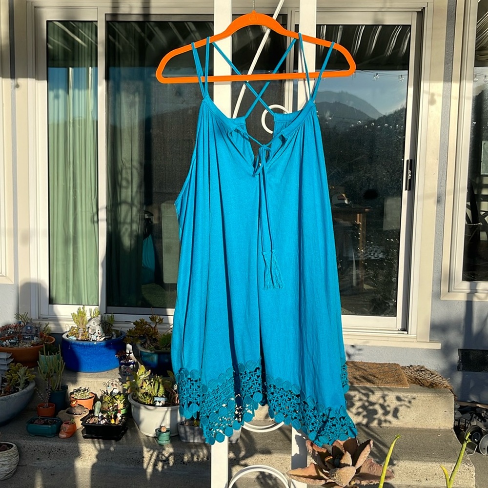 Deep turquoise spaghetti strap tank top that crisscrosses in the back